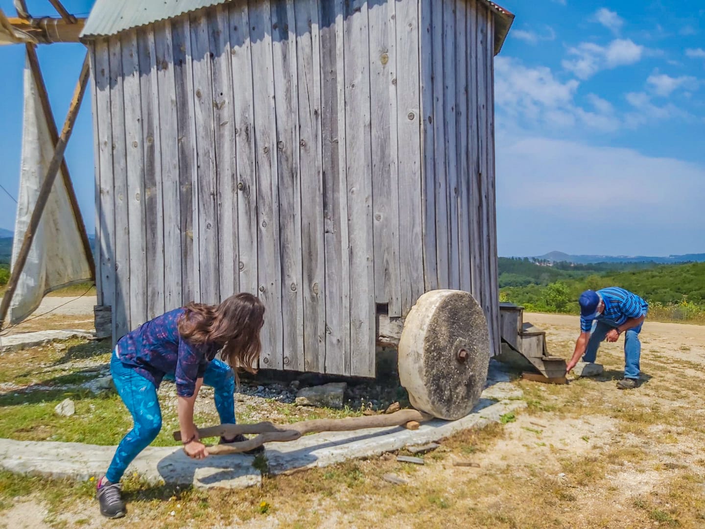 Participants beside a wooden windmill in Serra do Sicó