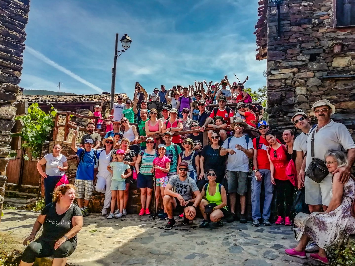 Walking group among schist buildings in Lousã