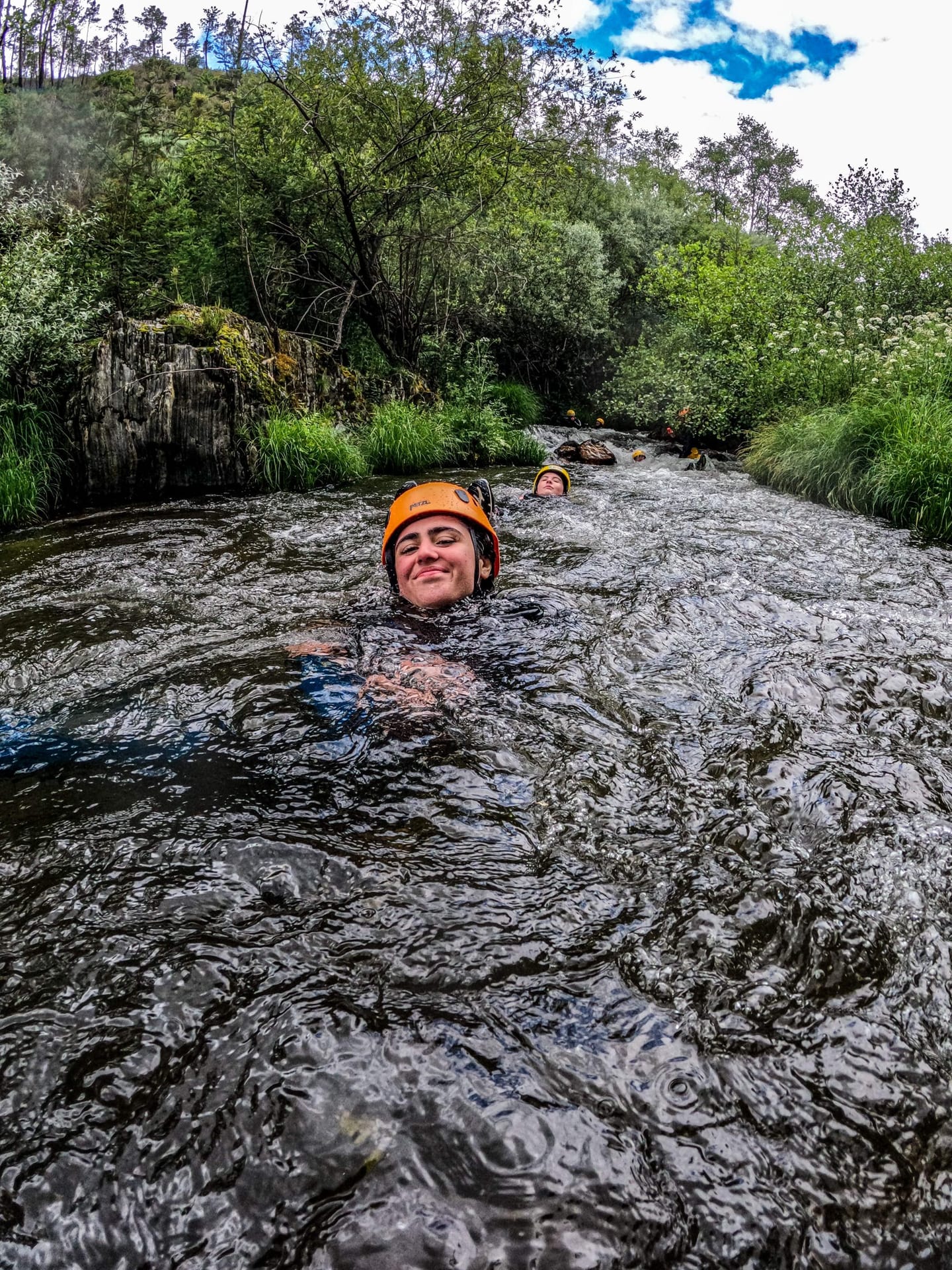 Helmeted participant progressing in the Ceira at Poço da Cesta