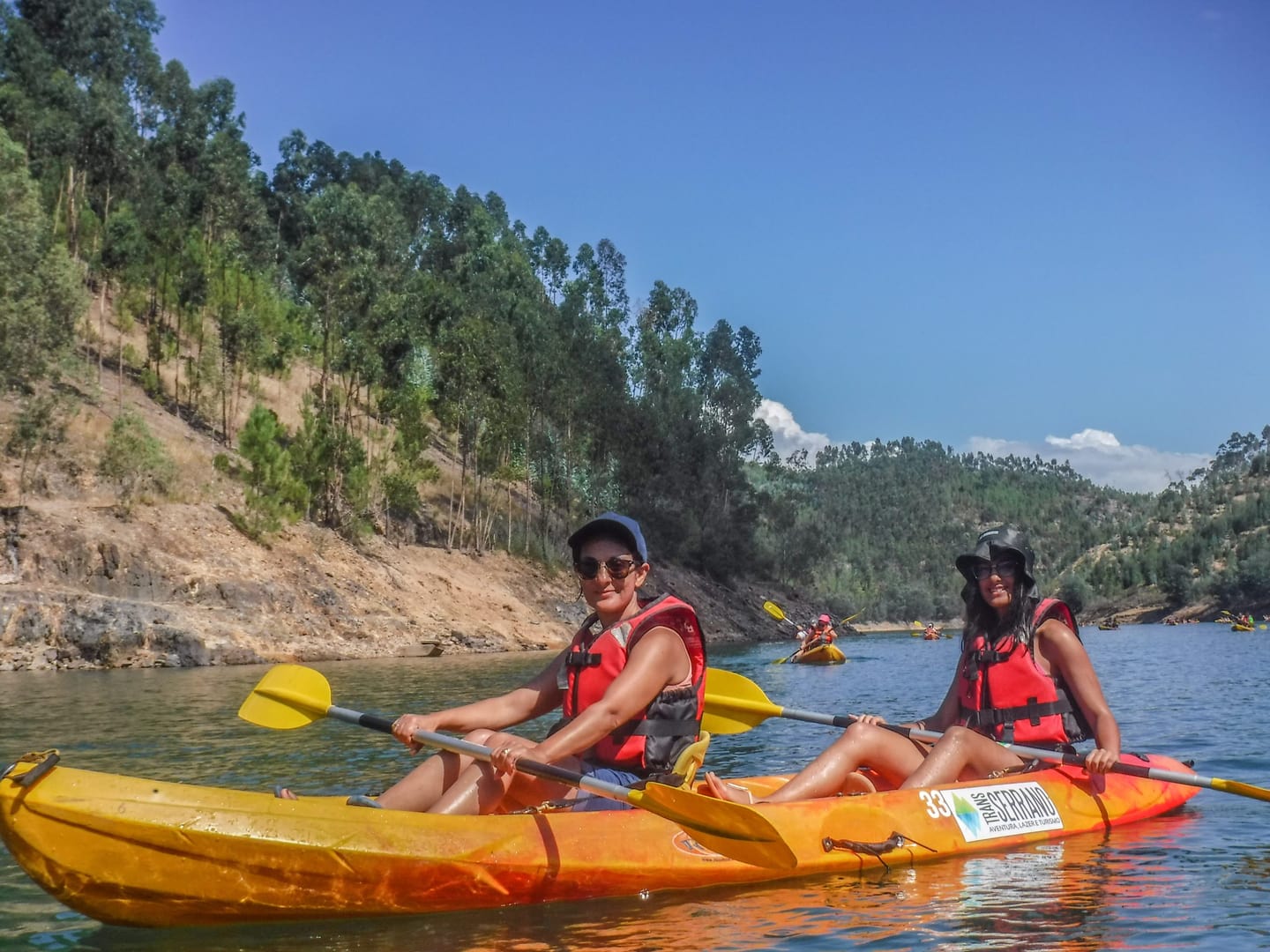 Canoeists on a broad Zêzere section beside rocky hillsides